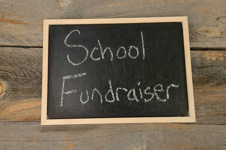 Top Three Good Fundraisers for Schools Written On Blackboard