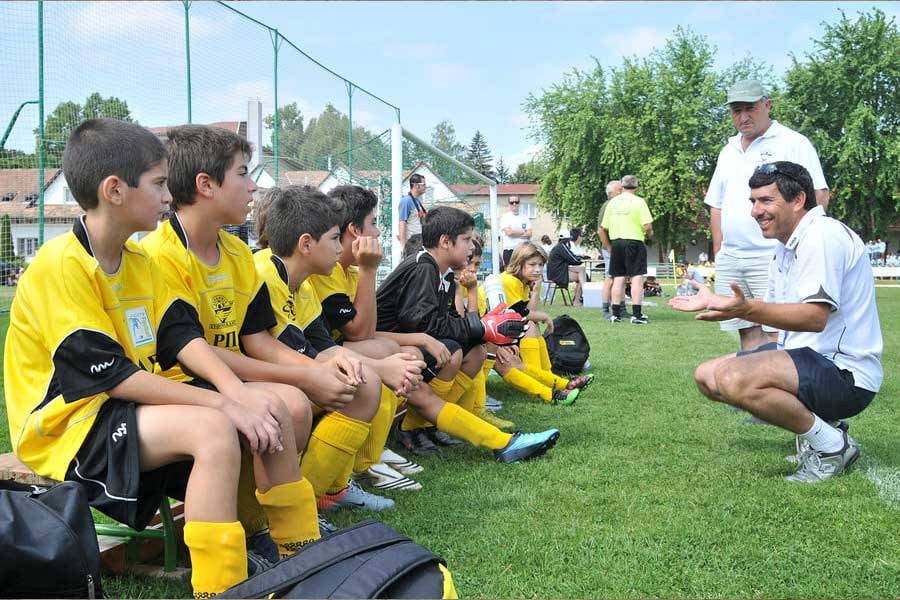 Coach Gives Instruction To Youth Soccer Team