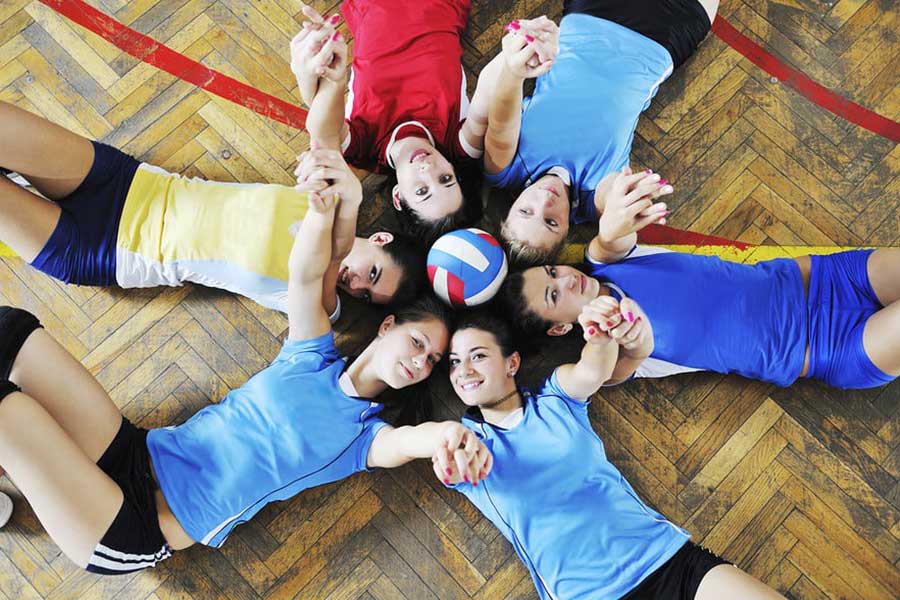 Girls Volleyball Team Displaying Teamwork
