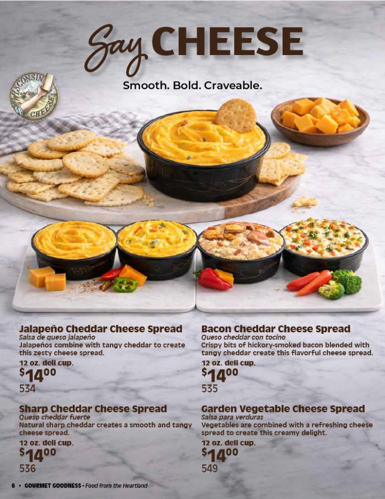 Four irresistible varieties of cheese spreads in sleek black containers are artfully arranged on a wooden surface, surrounded by crisp crackers, fresh vegetables, and savory cheese slices—perfect for your next fundraising catalog to help schools and organizations raise money.